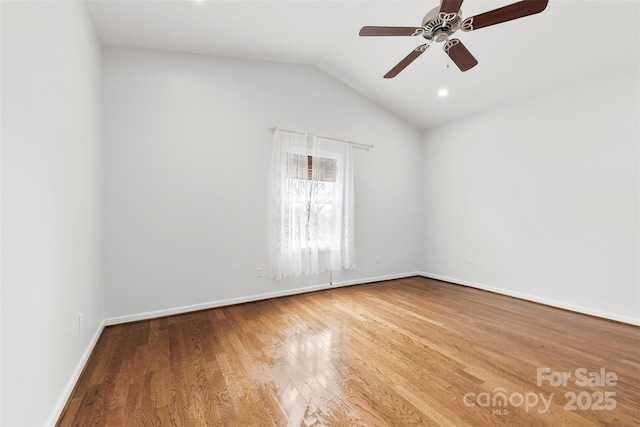 spare room with hardwood / wood-style flooring, ceiling fan, and lofted ceiling