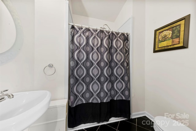 bathroom featuring tile patterned floors, toilet, and sink