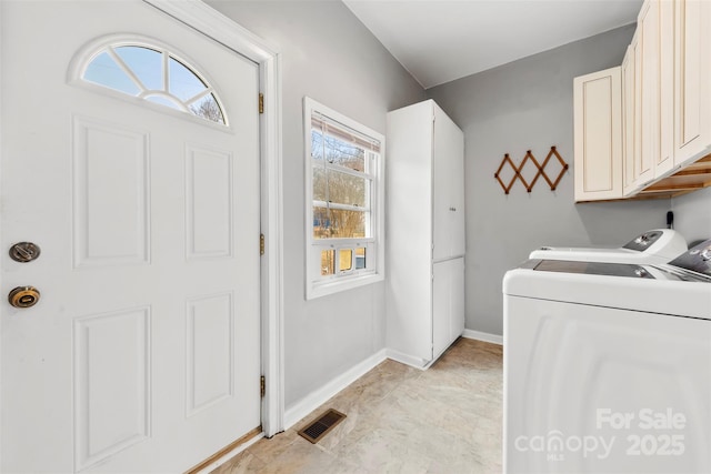 laundry area featuring cabinets and washing machine and dryer