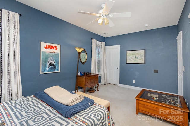 bedroom featuring baseboards, a ceiling fan, and light colored carpet