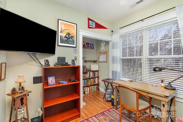 office space featuring visible vents and wood finished floors