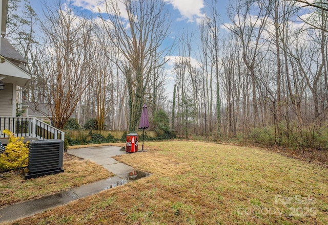 view of yard featuring cooling unit and fence