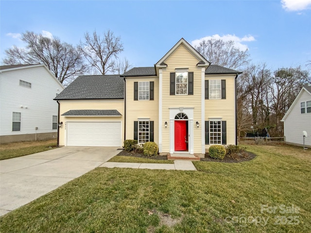 view of front of property with concrete driveway, a shingled roof, and a front yard