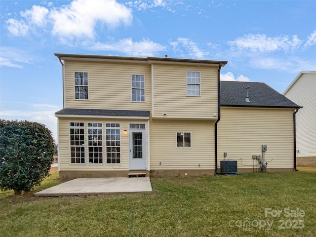 back of property featuring a yard, roof with shingles, a patio area, and central air condition unit