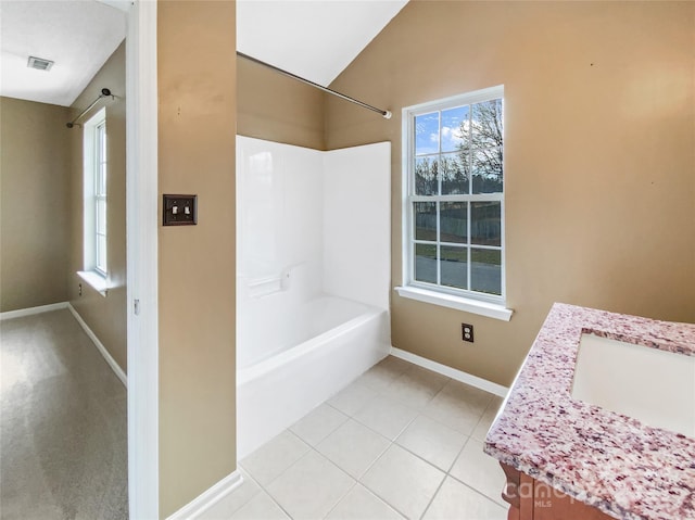 full bath with lofted ceiling, visible vents, baseboards, vanity, and tile patterned floors