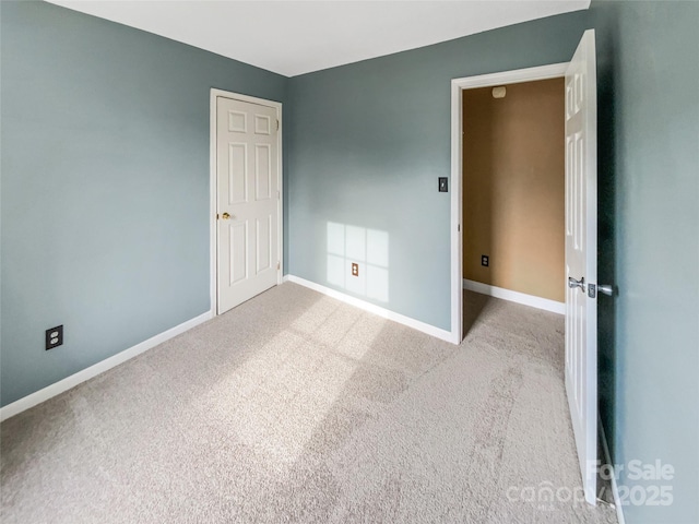 unfurnished bedroom with light carpet and baseboards