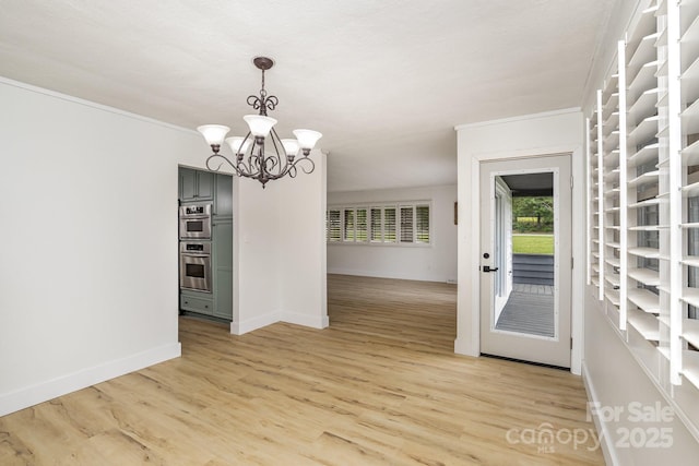 unfurnished dining area with light wood finished floors, baseboards, and an inviting chandelier