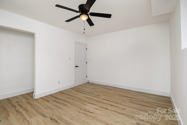 unfurnished bedroom with baseboards, a ceiling fan, and wood finished floors