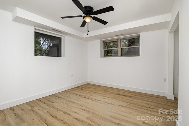 unfurnished room with visible vents, baseboards, a ceiling fan, and wood finished floors