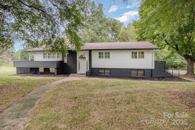 bi-level home with a front lawn