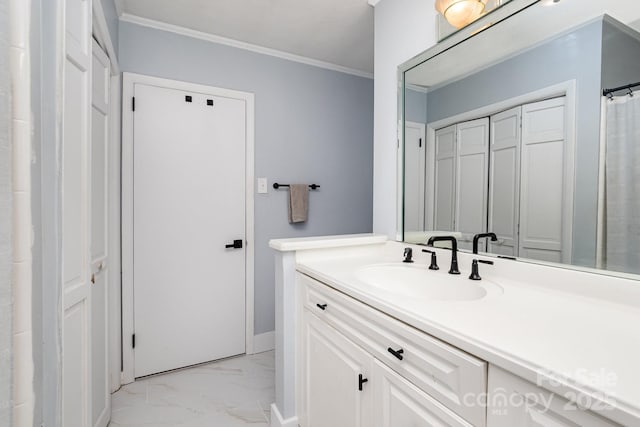 full bathroom featuring crown molding, marble finish floor, baseboards, and vanity