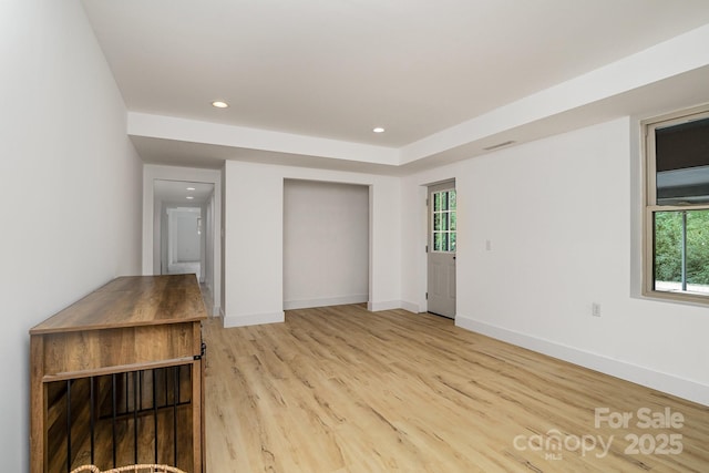 interior space with baseboards, recessed lighting, plenty of natural light, and light wood-style floors