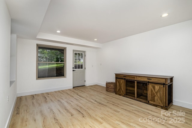 interior space featuring recessed lighting, baseboards, and wood finished floors