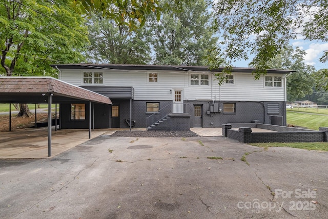 rear view of property with brick siding