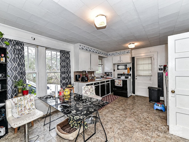 kitchen featuring white cabinetry and electric range