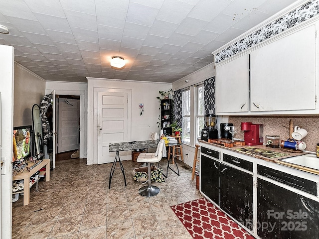 kitchen with white cabinetry and backsplash