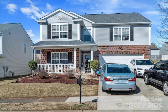 view of front of house featuring a garage, a front yard, and a porch