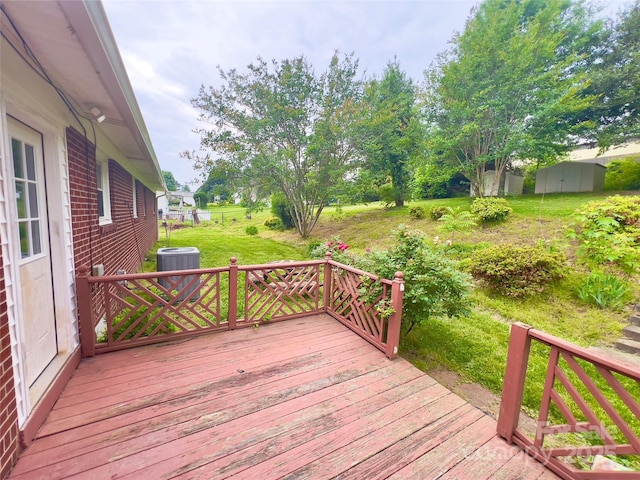 108 Meadowview Pl, Lenoir, NC 28645 - wooden terrace featuring central AC unit, a storage shed, and an outbuilding