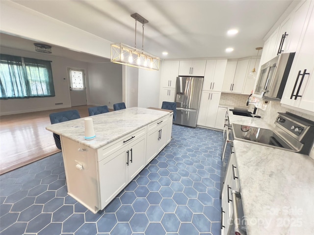 108 Meadowview Pl, Lenoir, NC 28645 - kitchen with appliances with stainless steel finishes, a kitchen island, dark tile patterned floors, recessed lighting, and white cabinetry