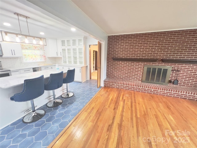 108 Meadowview Pl, Lenoir, NC 28645 - living area featuring light wood-style flooring, brick wall, and a brick fireplace