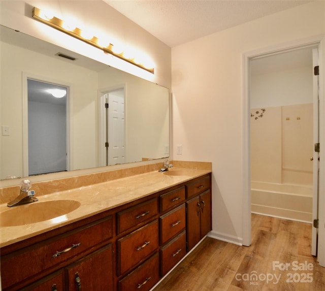 bathroom with hardwood / wood-style flooring and vanity