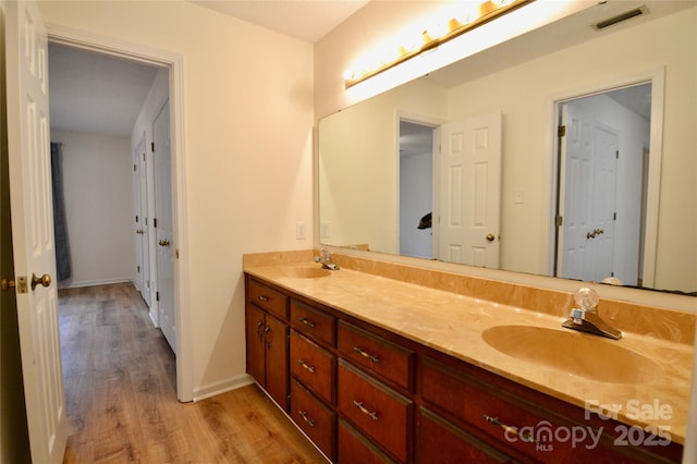 bathroom featuring hardwood / wood-style flooring and vanity