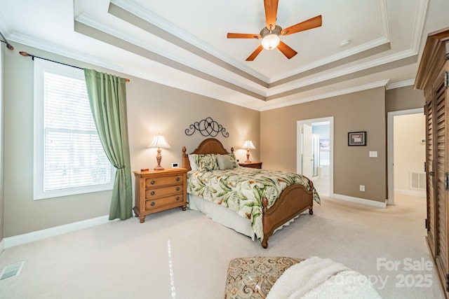 bedroom featuring baseboards, a raised ceiling, visible vents, and light colored carpet