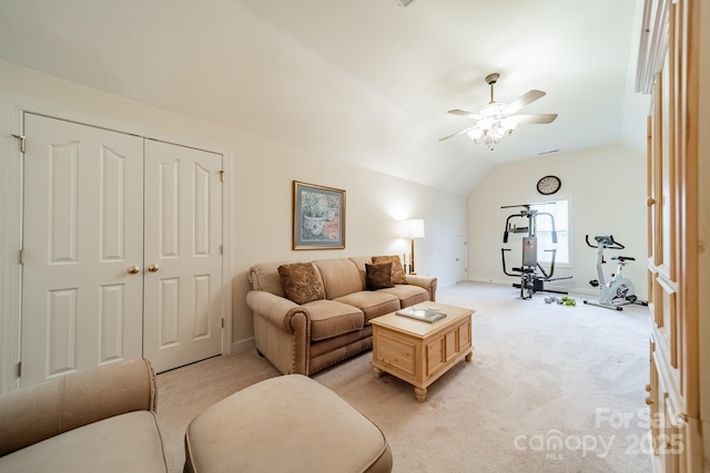 living area featuring a ceiling fan, light colored carpet, and vaulted ceiling