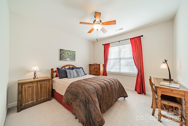 bedroom with light carpet, a ceiling fan, visible vents, and baseboards