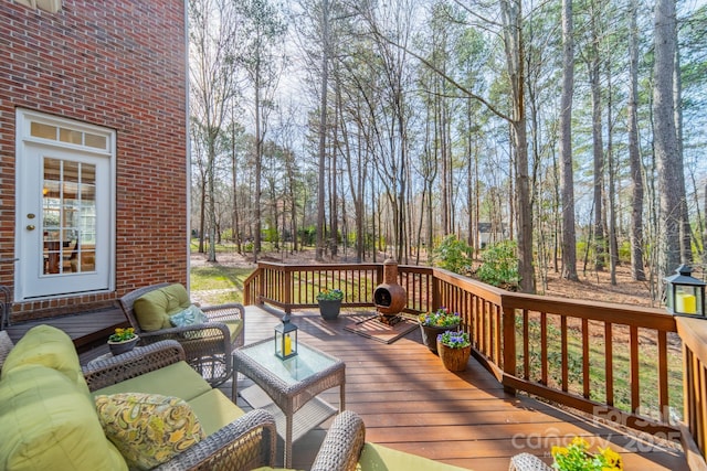 wooden terrace with an outdoor hangout area