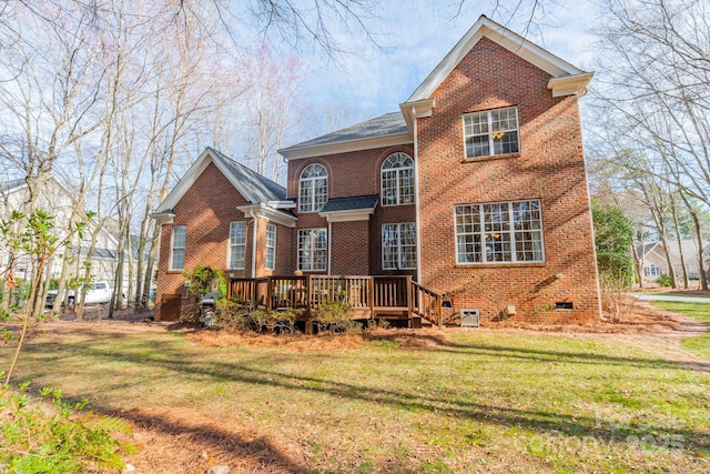 back of house with crawl space, brick siding, a lawn, and a deck