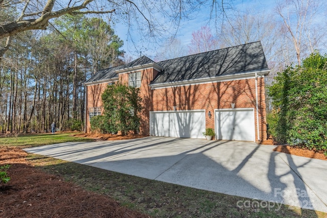 view of front of home featuring brick siding and driveway