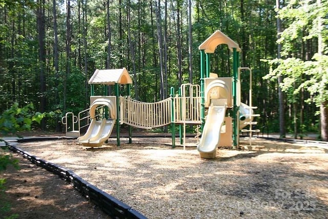 community jungle gym with a forest view