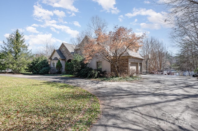 view of front of home with a garage and a front lawn