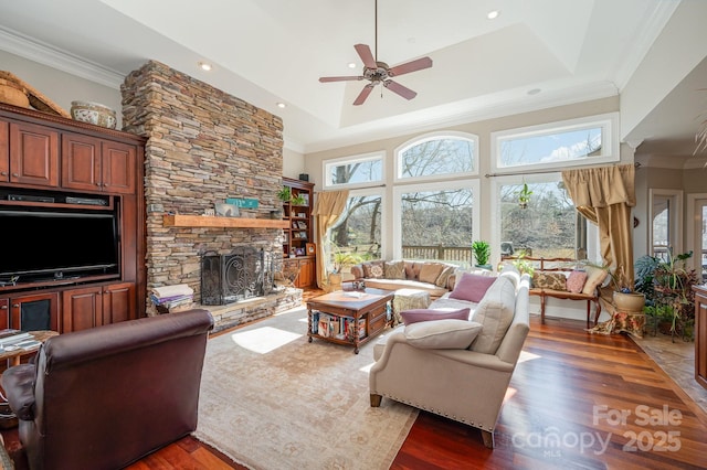 living room featuring dark wood-type flooring, crown molding, and a wealth of natural light