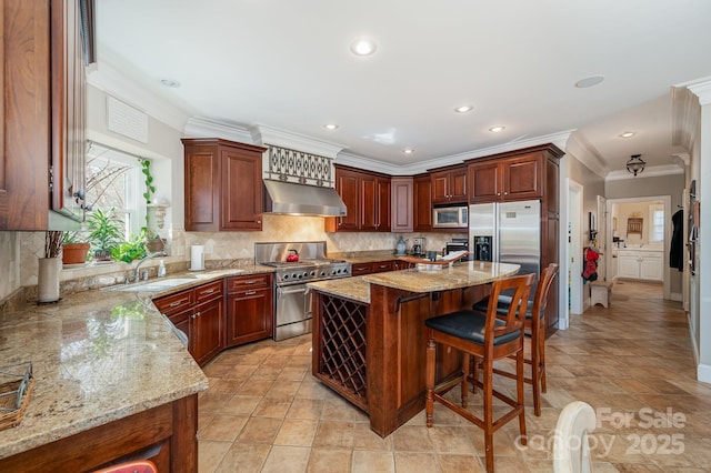 kitchen with stainless steel appliances, light stone countertops, ventilation hood, a kitchen island, and sink