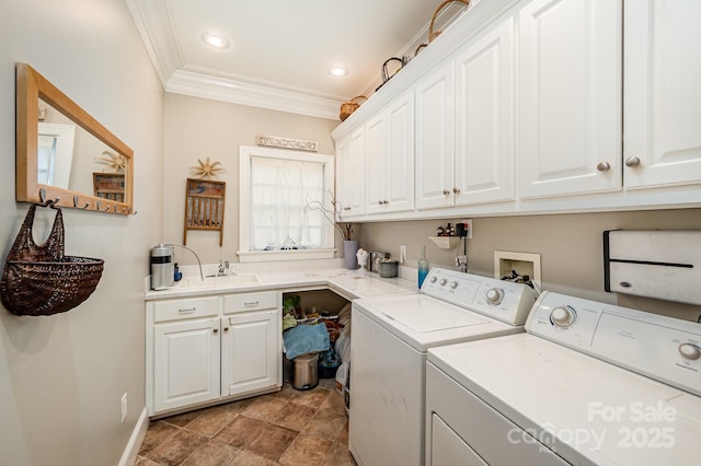 washroom with sink, cabinets, crown molding, and washing machine and clothes dryer