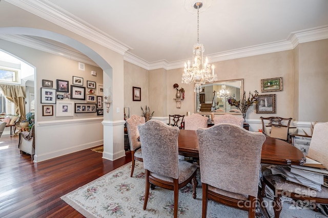 dining space featuring crown molding, a chandelier, and dark wood-type flooring