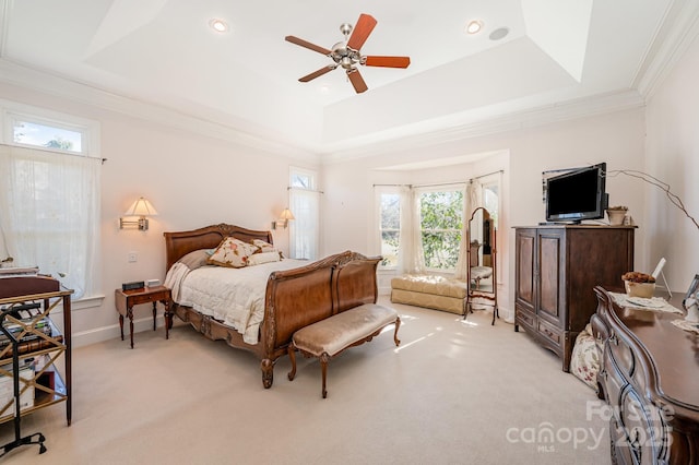 carpeted bedroom with ornamental molding and a raised ceiling