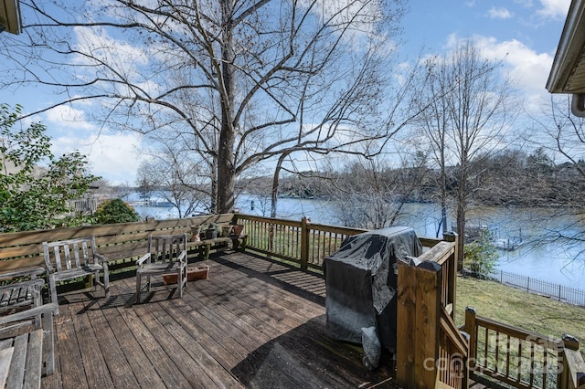 deck with a water view and grilling area