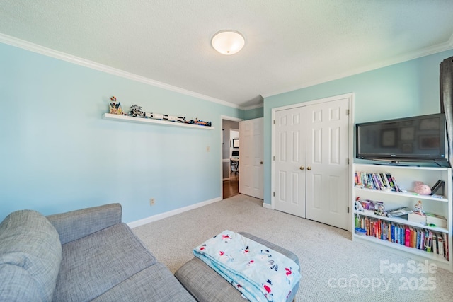 carpeted living area with baseboards, ornamental molding, and a textured ceiling