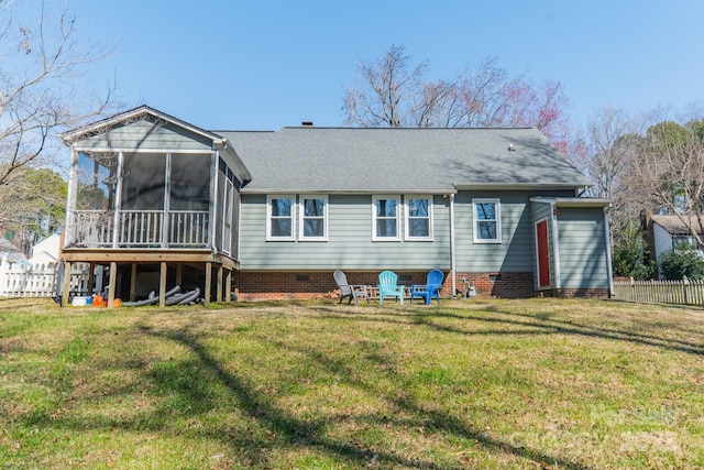 rear view of property featuring a sunroom, fence, and a yard