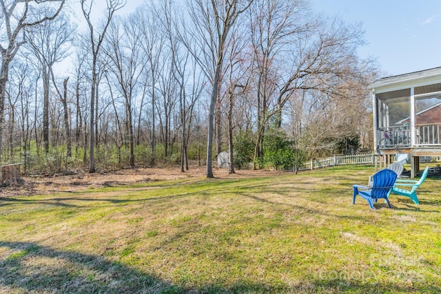 view of yard featuring a sunroom and fence