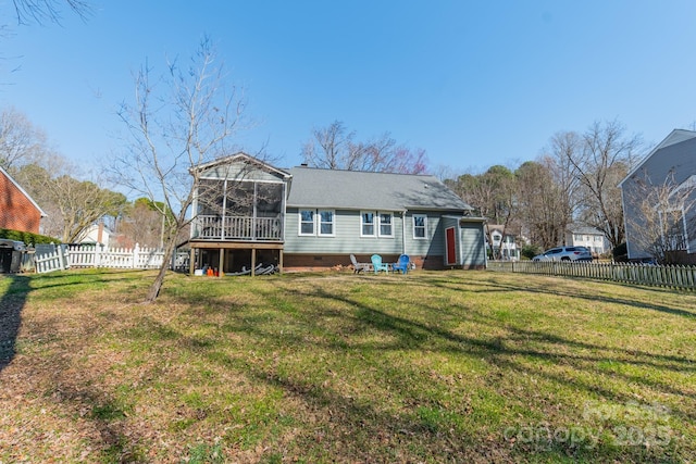 back of property featuring a sunroom, a fenced backyard, and a yard