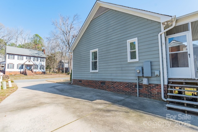 view of home's exterior with entry steps and crawl space