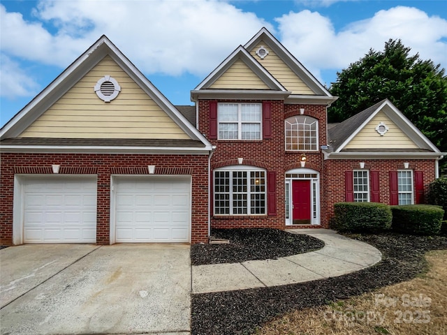 view of front of property with brick siding, driveway, and an attached garage