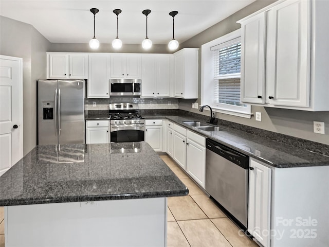 kitchen with white cabinetry, a kitchen island, pendant lighting, and stainless steel appliances