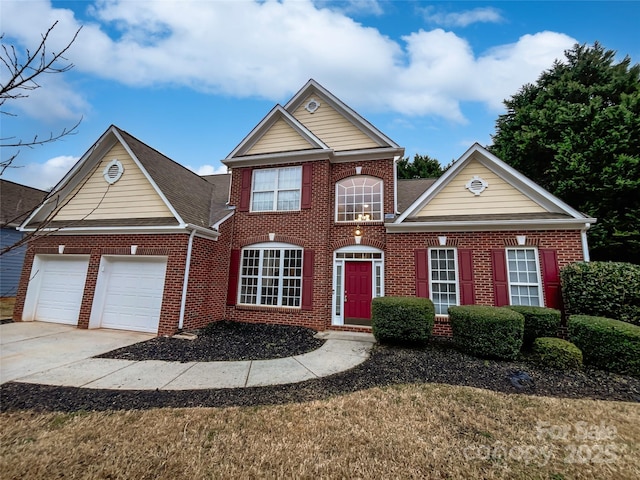 view of front facade with driveway, brick siding, and an attached garage