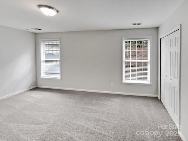 interior space with carpet, visible vents, and baseboards