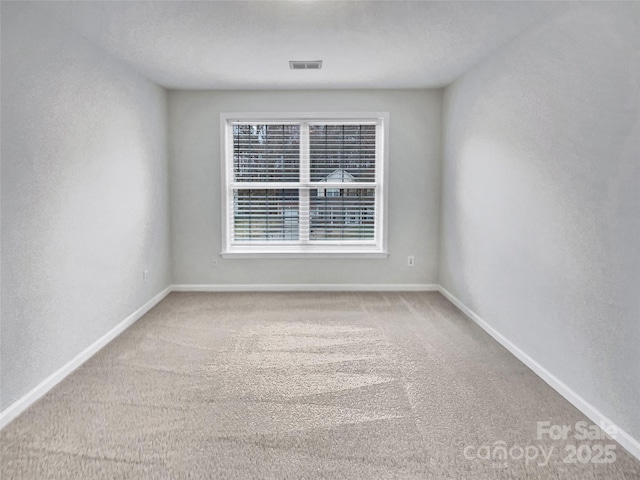 unfurnished room with light carpet, baseboards, and visible vents